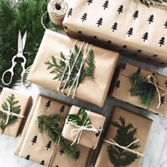 wrapping presents wrapped in brown paper and tied with twine, pine tree print on them