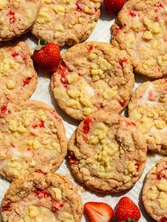 strawberry shortbread cookies with icing and fresh strawberries on the side, ready to be eaten