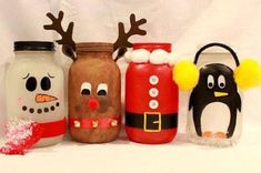 four decorated jars with faces and noses are lined up against a white background, one has a penguin, the other is santa claus