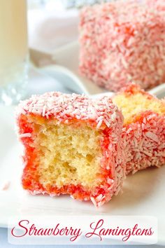 two pieces of cake on a white plate with strawberries and milk in the background