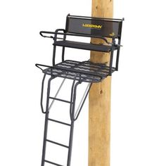 a wooden pole with a ladder attached to it and a metal rack on the top