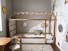 a child's room with a bed, desk and chair