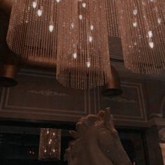 a large chandelier hanging from the ceiling in a room with many lights on it