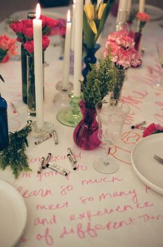 a table topped with lots of candles and flowers