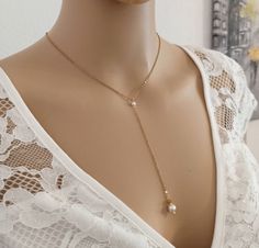 Necklace wedding pearls steel chain This pretty Y-necklace made with a fine steel chain gilded with fine 18K gold is the trendy and refined necklace. He will know how to perfect a pretty V-neckline by dressing it delicately. It is made with a steel chain, you can choose the length: 40 cm, 42 cm, 45 cm, 50 cm, it will have an extension chain of about 5 cm ending with a small golden steel heart. The pendant in front is made with a small Swarovski bead element of 4 mm (I can put one of 6 mm if you Elegant Chain Jewelry For Weddings, Elegant Wedding Jewelry Chain, Elegant Bridal Necklace Gift With Chain Detail, Elegant Bridal Necklace With Chain For Wedding, Gold Drop Necklace With Pearl Charm For Wedding, Elegant Chain Necklace For Wedding, Delicate Gold Drop Necklace For Wedding, Elegant Yellow Gold Chain Necklace For Wedding, Delicate Pearl Chain Backdrop Necklace As Gift