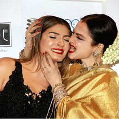 two women are touching each other while posing for the camera with their faces close together