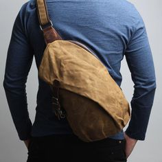 The Vintage Shoulder Sling Backpack Waxed Canvas Mens Messenger Crossbody Bag is a stylish and functional bag perfect for everyday use. It is made of high-quality waterproof waxed canvas material and features a classic, timeless design that is ideal for both men and women. The bag is equipped with multiple pockets and compartments to keep your items organized and secure, and comes with an adjustable shoulder strap for easy carrying. This bag is perfect for work, school, or travel.    The crossbody bag made with high quality waxed canvas, which is very sturdy and wear-resistant, excellent water resistance can protect your stored items effectively Versatile backpack with plenty room for your iPad, wallet, umbrella and other essentials, a zip pocket on the back to store your valuables and pre Canvas Duffle Bag Men, Waxed Canvas Leather Backpack, Cross Shoulder Bag, Sling Bag Men, Canvas Sling Bag, Canvas Duffle Bag, Mens Crossbody Bag, Cross Shoulder Bags, Leather Weekender Bag