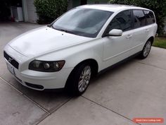 a white car parked in front of a house