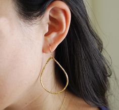 Gold plated teardrop hoops measure 2 inches in length and 1.25 in width. The ear hook is 14k gold fill. Also available in silver. These are great everyday earrings. Item comes packaged in a little brown box. Elegant Teardrop Hammered Hoop Earrings, Gold Long Drop Teardrop Earrings For Everyday, Yellow Gold Teardrop Hoop Earrings For Everyday, Everyday Gold Long Drop Teardrop Earrings, Everyday Long Drop Gold Teardrop Earrings, Everyday Yellow Gold Teardrop Hoop Earrings, Everyday Long Drop Hoop Earrings With Ear Wire, Gold Teardrop Threader Earrings Minimalist Style, Gold Teardrop Threader Earrings For Everyday