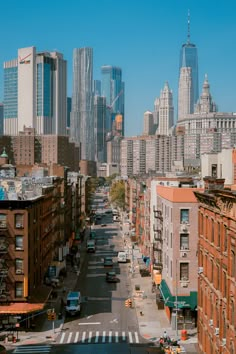 an empty city street with tall buildings in the background