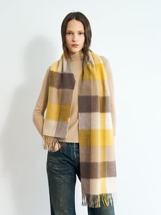 Lost Pattern's plaid cashmere scarf in yellow serves as a statement piece that effortlessly enhances your everyday look, adding a dose of elegance and refinement. This ultra soft cashmere scarf is crafted with the utmost attention to detail, providing a luxurious feel and ensuring warmth and comfort during colder seasons.   Woven with 100% pure cashmere from Mongolia Heavenly soft, fringed ends on both sides Plaid design in yellow Dry clean only. Yellow Winter Scarves, Soft Fringe, Cashmere Shawl, Orange Plaid, Conscious Fashion, Shawl Wrap, New York Street, Neck Scarf, Plaid Design