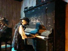 two mannequins are sitting at a piano