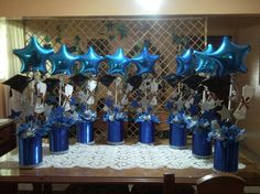 a table with blue vases and balloons on it