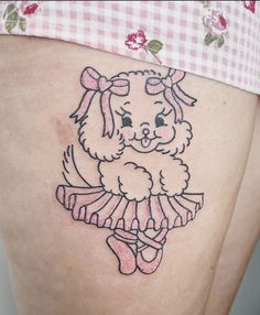 a woman's thigh with a small tattoo of a dog in a dress on it