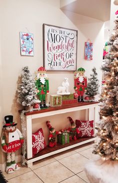 a christmas display in the corner of a room with decorations on it and a tree