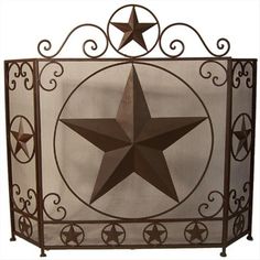 a metal fire place cover with a star on it