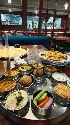 a table filled with lots of food on top of metal pans next to each other