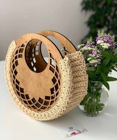 two baskets sitting on top of a table next to a vase with flowers in it