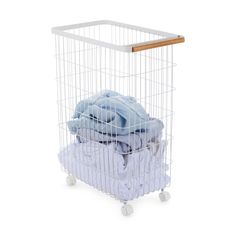 a white laundry basket with clothes in it