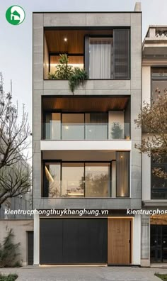 an apartment building with two garages and plants on the balconies