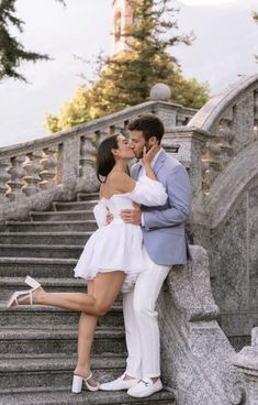 a man and woman kissing on the steps