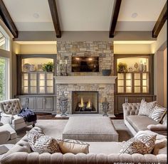 a living room filled with furniture and a fire place in the middle of it's walls