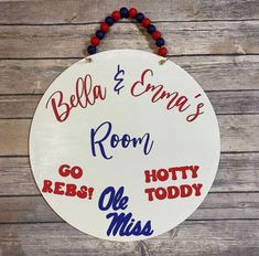 a white sign with red, white and blue writing on it that says bella & creme's room