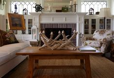 a living room filled with furniture and a fire place in front of a fireplace covered in candles