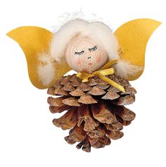 an angel doll sitting on top of a pine cone with wings and eyes painted yellow