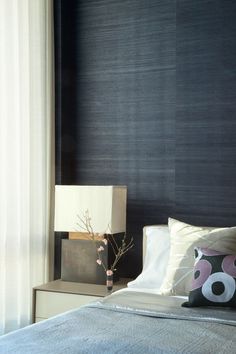 a bedroom with black walls and white curtains