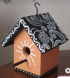 a birdhouse with an umbrella on top of it