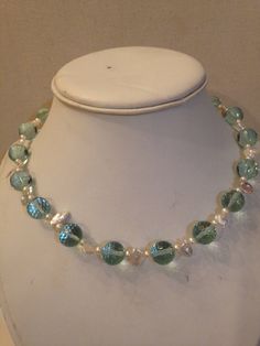 Beautiful vintage choker necklace with faceted Simulated Aquamarine Beads, seed pearls and small petal pearls with sterling lock. circa 1980's. the total length of this choker necklace is 17 inches. there are 17 simulated aquamarine beads which are in great shape with no defects. a statement piece of a necklace. this will be a great gift for one classy lady. Pearl Single Strand Choker With Round Beads, Single Strand Pearl Choker With Round Beads, Rondelle Beaded Pearl Necklaces, Beaded Pearl Rondelle Necklaces, Beaded Pearl Rondelle Necklace, Pearl Rondelle Jewelry With Faceted Beads, Vintage Pearl Beaded Choker, Rondelle Pearl Jewelry With Faceted Beads, Round Beaded Necklaces With Pearl Drop For Jewelry Making