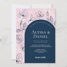 an elegant wedding card with flowers and leaves on the front, in navy blue and pink