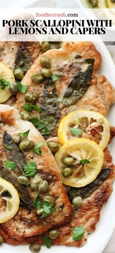 grilled fish with lemons and capers on a white plate next to olives