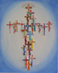 a cross made out of colored paper on a blue background