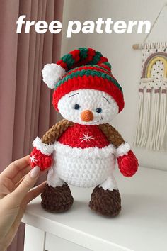 a crocheted snowman with a hat and scarf