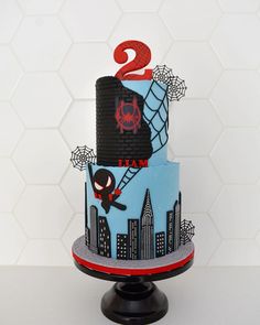 a spiderman themed birthday cake with the number two on it's top tier