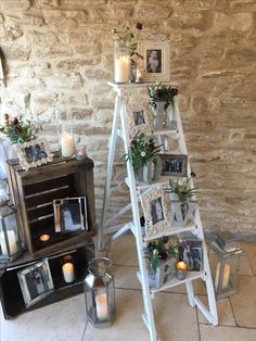 a white ladder with pictures and candles on it