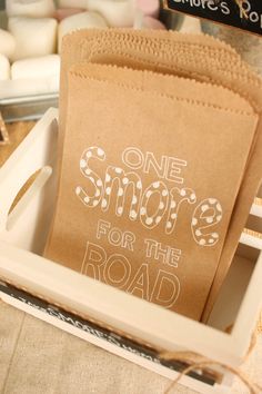 a brown paper bag with the words one shop for the road printed on it sitting in a white tray