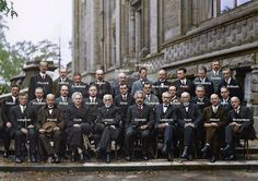 an old photograph of men in suits and ties posing for a group photo on steps