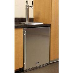 a stainless steel dishwasher sitting on top of a counter next to a sink