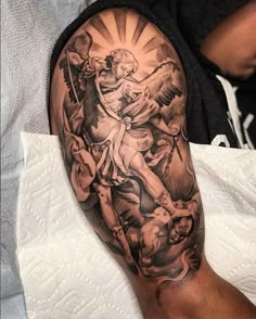 a man's arm with an angel and cherub tattoo on the left forearm