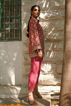 A fresh spin on a classic silhouette - a coral printed khaddi silk jacket with gota and zardoze work and colourful tassel details. The look is completed with a coral raw silk shalwar embellished with embroidered floral motifs. Pink Embroidered Lawn Suit, Festive Pink Printed Lawn Suit, Festive Semi-stitched Orange Lawn Suit, Festive Orange Semi-stitched Lawn Suit, Festive Semi-stitched Embellished Lawn Suit, Bridal Suits Punjabi, Coral Print, Website Features, Silk Jacket