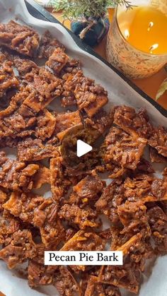 pecan pie bark on a platter next to a bowl of honey and tea