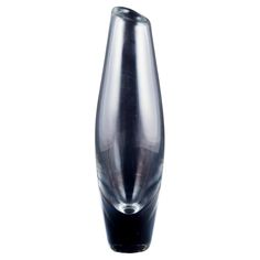 a black and clear vase sitting on top of a table