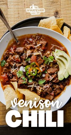 a bowl of chili with tortilla chips on the side