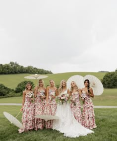 a group of women standing next to each other holding umbrellas