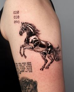 a woman's arm with a horse tattoo on the left side of her body