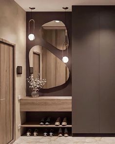 a bathroom with a large mirror and some shoes on the floor in front of it