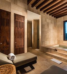 a large bathroom with a jacuzzi tub next to a wooden door and window